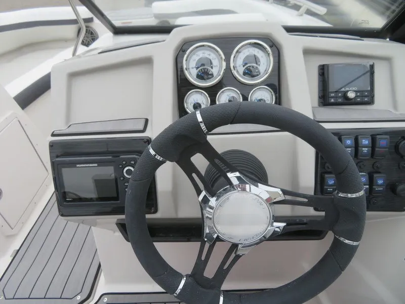 Slide: The Image of 2023 Starcraft SVX IO 210 boat dashboard with steering wheel and gauges. - 12