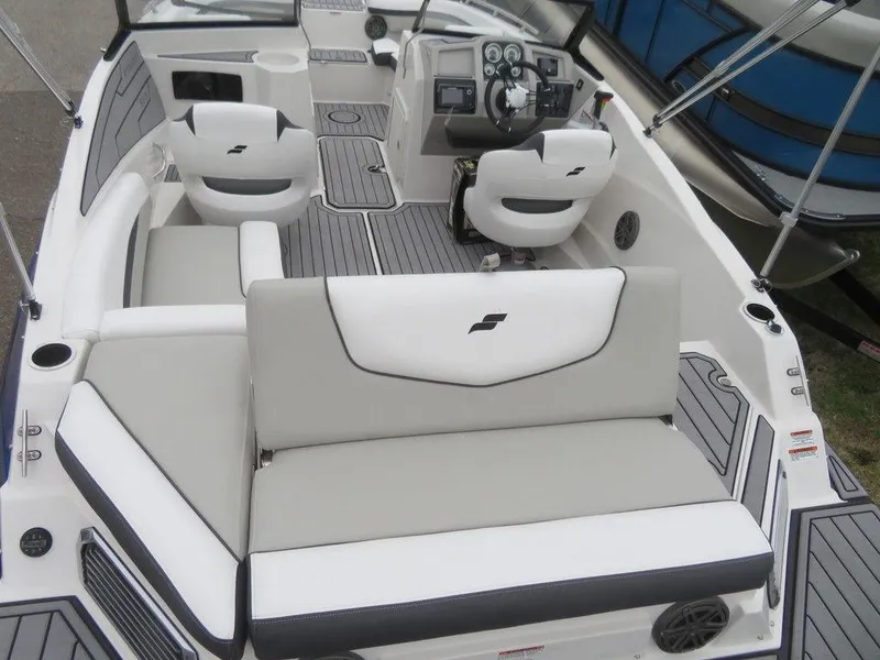 Slide: The Image of 2023 Starcraft SVX IO 210 boat interior with white and gray seating. - 16