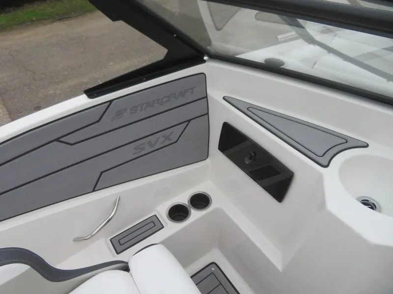 Slide: The Image of 2023 Starcraft SVX IO 210 boat interior, featuring cup holders and sleek design. - 9