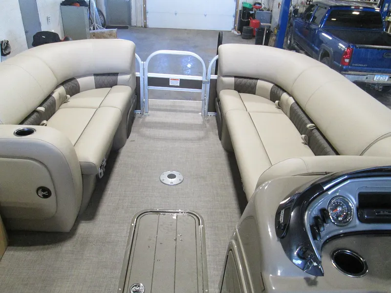 Slide: The Image of 2023 Sun Tracker SportFish 22 XP3 interior with beige seating and control panel. - 7