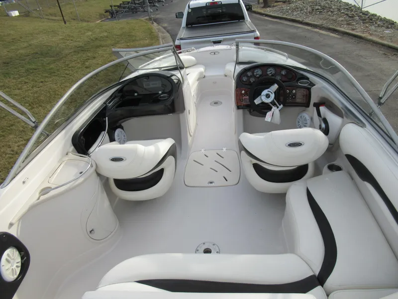 Slide: The Image of 2007 Tahoe Q8i boat interior with white seating and dashboard. - 10