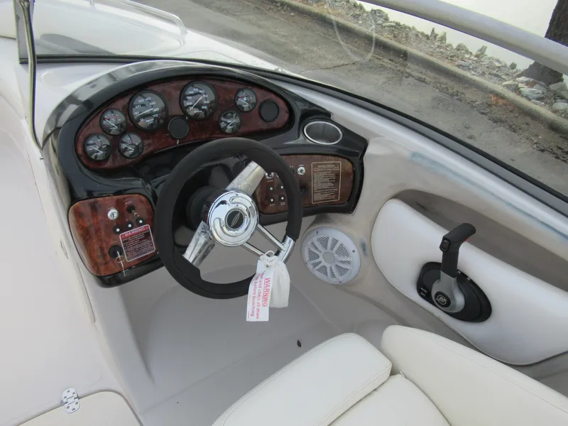 Slide: The Image of 2007 Tahoe Q8i boat dashboard with steering wheel and control panel. - 12
