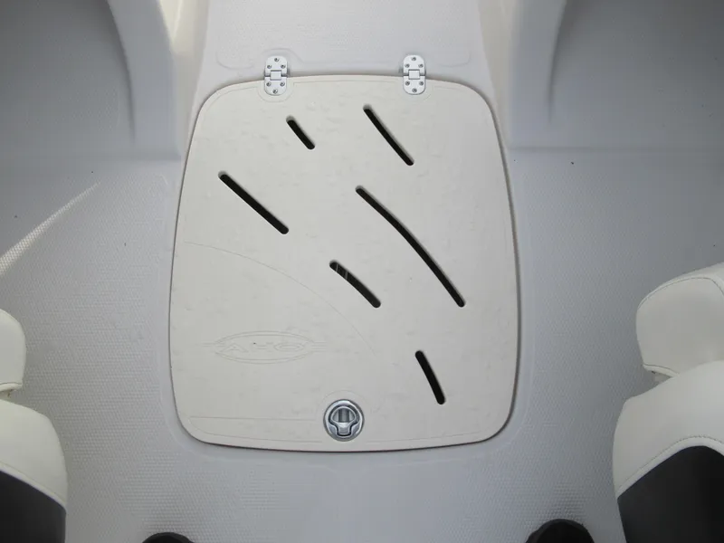 Slide: The Image of 2007 Tahoe Q8i boat storage compartment with white cover and black slots. - 13