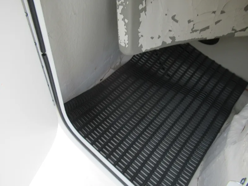 Slide: The Image of 2007 Tahoe Q8i boat interior with black floor mat. - 18