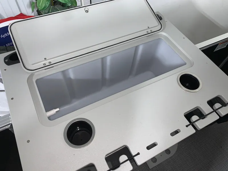 Slide: The Image of 2024 Starcraft EX22 FD boat storage compartment with cup holders. - 10