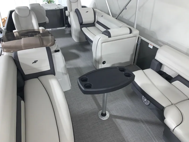 Slide: The Image of 2024 Starcraft EX22 FD boat interior with plush seating and table. - 4