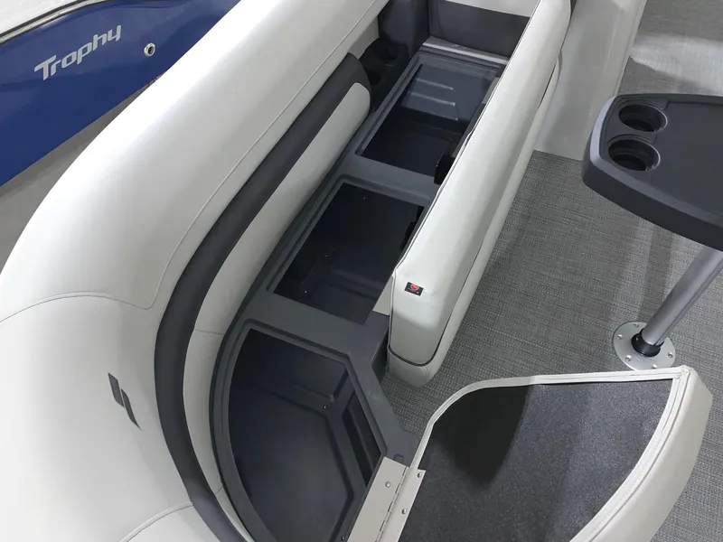 Slide: The Image of 2024 Starcraft EX22 FD boat interior with storage compartments and cup holders. - 5