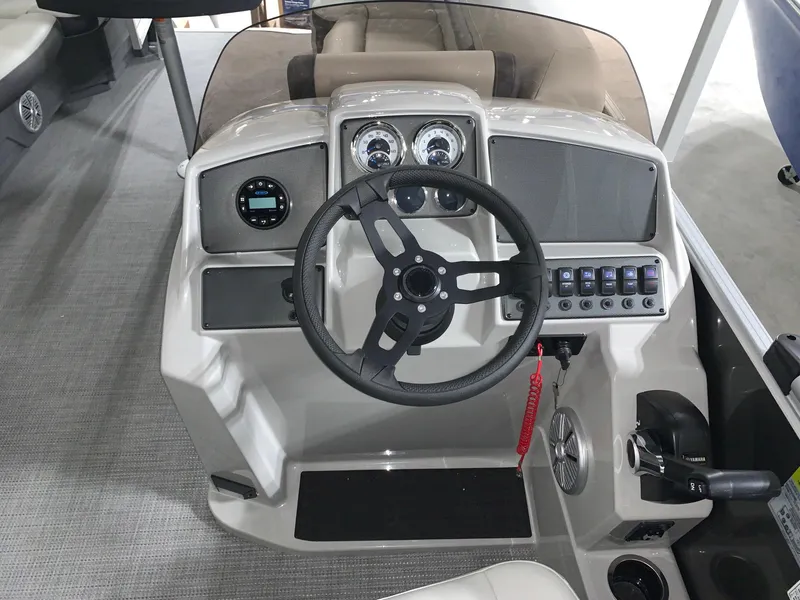 Slide: The Image of 2024 Starcraft EX22 FD boat dashboard with steering wheel and control panel. - 7