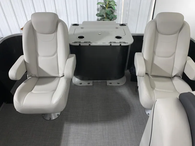 Slide: The Image of 2024 Starcraft EX22 FD boat interior with two white captain chairs and a central table. - 8