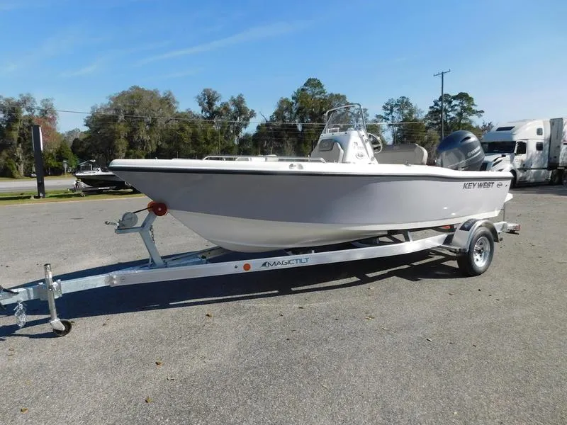 Slide: The Image of 2023 Key West 179FS boat on a trailer in a parking lot. - 2