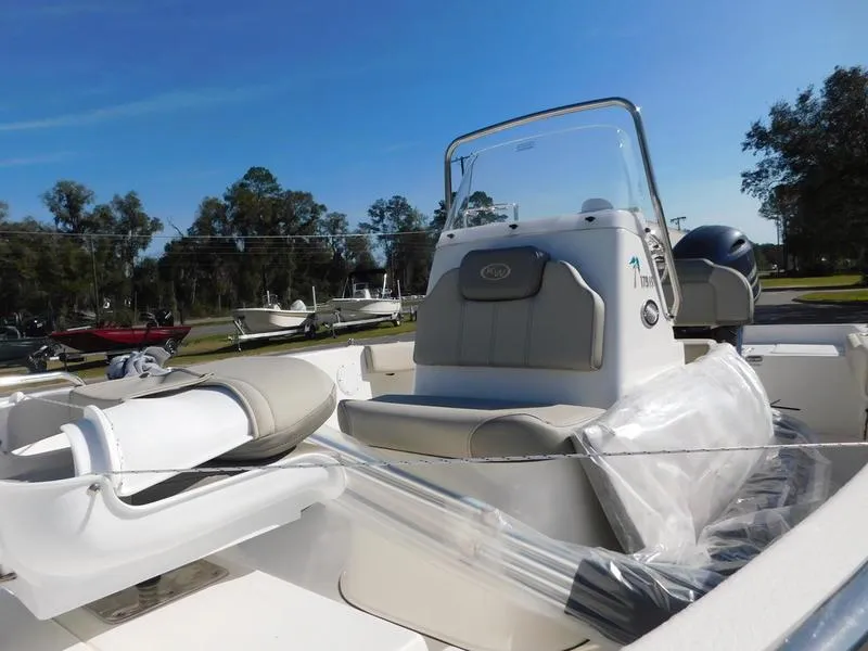 Slide: The Image of 2023 Key West 179FS boat with center console and seating, parked outdoors. - 8
