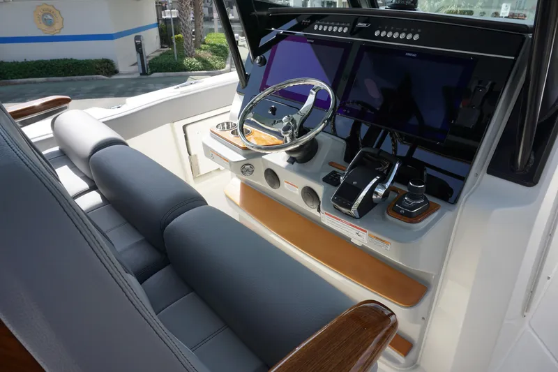 Slide: The Image of 2024 Boston Whaler 360 Outrage helm with dual screens and leather seating. - 13