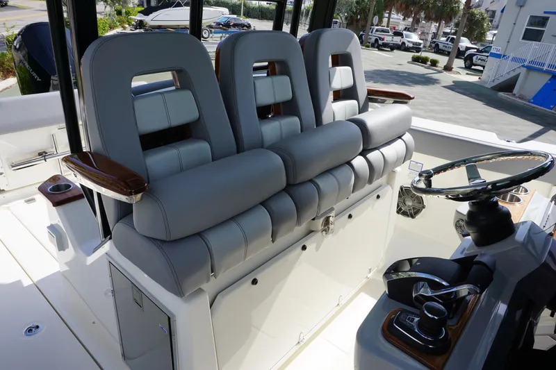 Slide: The Image of 2024 Boston Whaler 360 Outrage boat interior with luxurious seating and modern helm. - 14