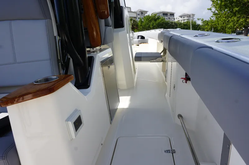 Slide: The Image of Boston Whaler 360 Outrage 2024 boat interior with seating and storage compartments. - 18