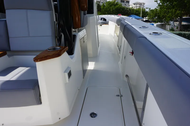 Slide: The Image of 2024 Boston Whaler 360 Outrage boat interior with seating and storage compartments. - 19