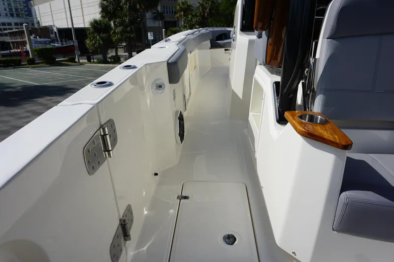 Slide: The Image of 2024 Boston Whaler 360 Outrage boat deck with seating and cup holder. - 20