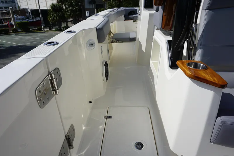 Slide: The Image of 2024 Boston Whaler 360 Outrage boat deck with seating and storage compartments. - 21