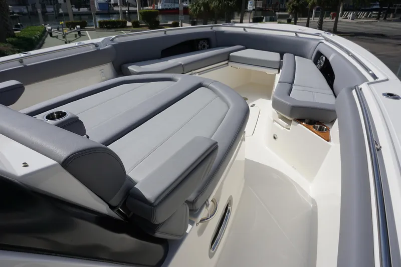 Slide: The Image of 2024 Boston Whaler 360 Outrage boat interior with cushioned seating and cup holders. - 23