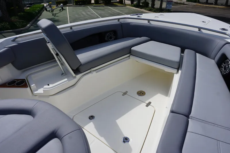 Slide: The Image of 2024 Boston Whaler 360 Outrage boat interior seating area with storage compartments. - 24