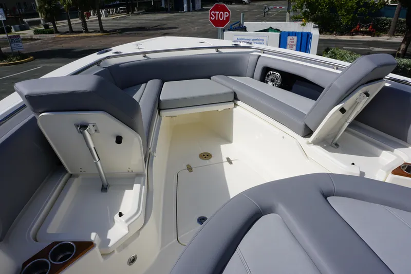Slide: The Image of 2024 Boston Whaler 360 Outrage boat interior with gray seating and storage compartments. - 25