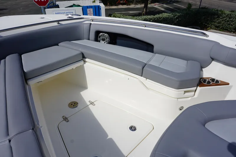 Slide: The Image of 2024 Boston Whaler 360 Outrage boat interior with cushioned seating and cup holders. - 27