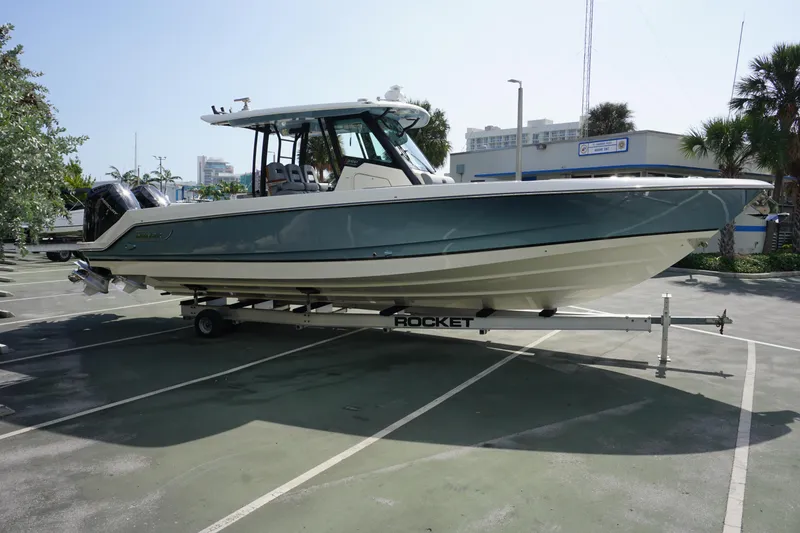 Slide: The Image of 2024 Boston Whaler 360 Outrage boat on a trailer in a parking lot. - 3