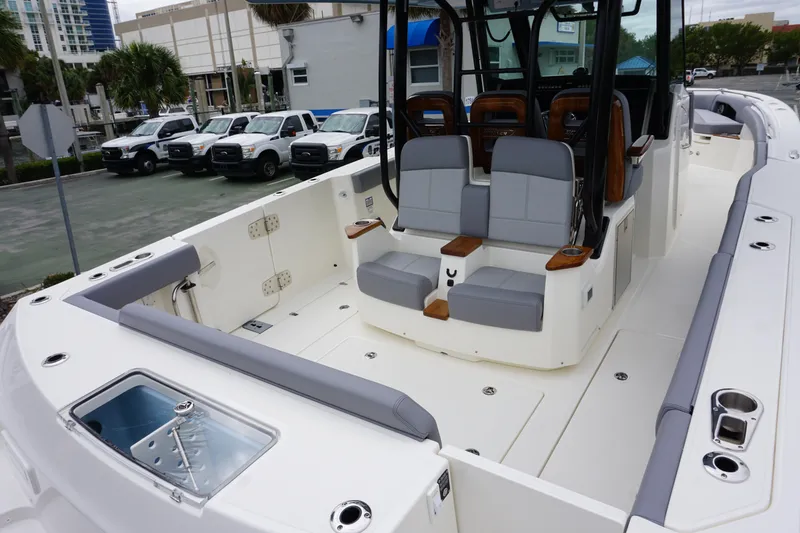 Slide: The Image of 2024 Boston Whaler 360 Outrage boat interior with seating and storage compartments. - 32