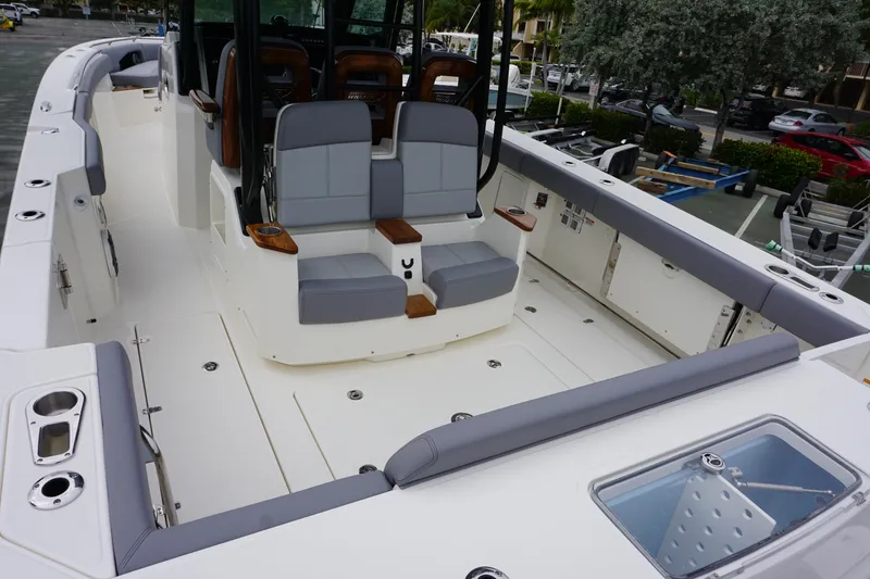 Slide: The Image of 2024 Boston Whaler 360 Outrage boat interior with seating and storage compartments. - 33