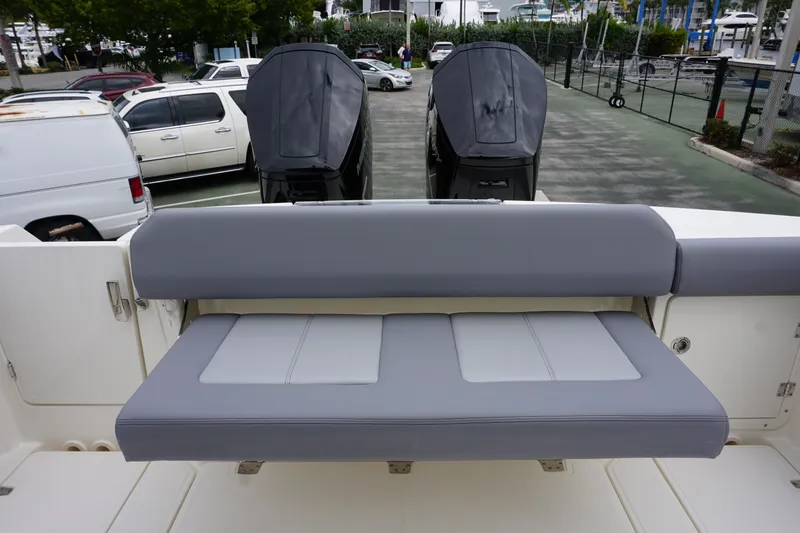 Slide: The Image of 2024 Boston Whaler 360 Outrage boat with dual outboard engines and rear seating. - 35