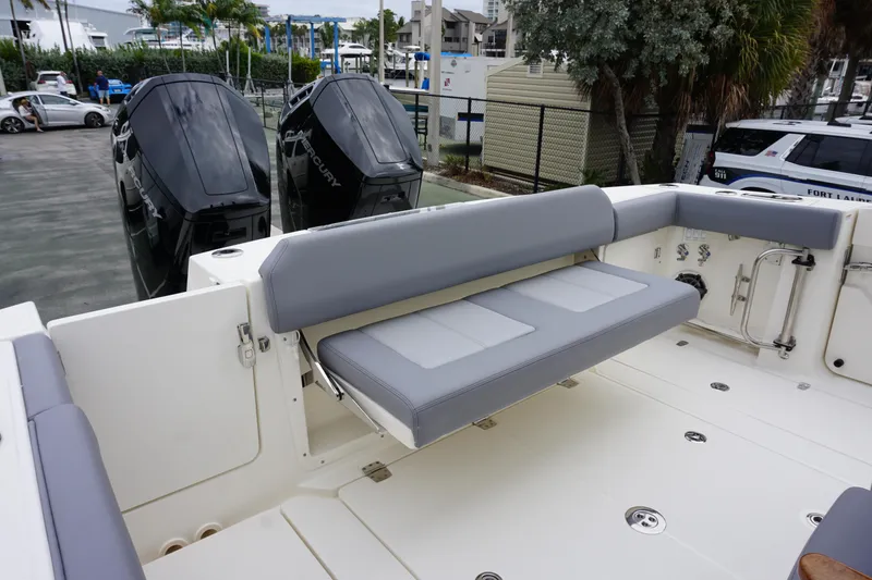 Slide: The Image of 2024 Boston Whaler 360 Outrage boat with rear seating and twin outboard engines. - 36