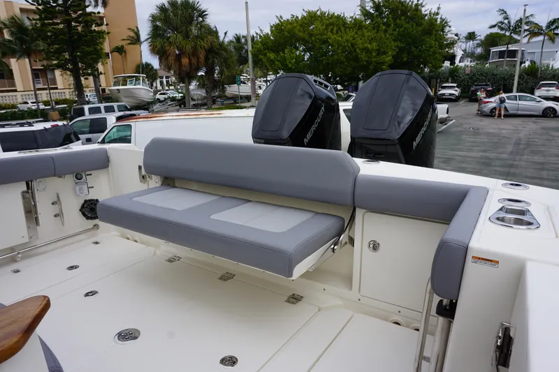 Slide: The Image of 2024 Boston Whaler 360 Outrage boat with dual outboard engines and rear seating. - 37