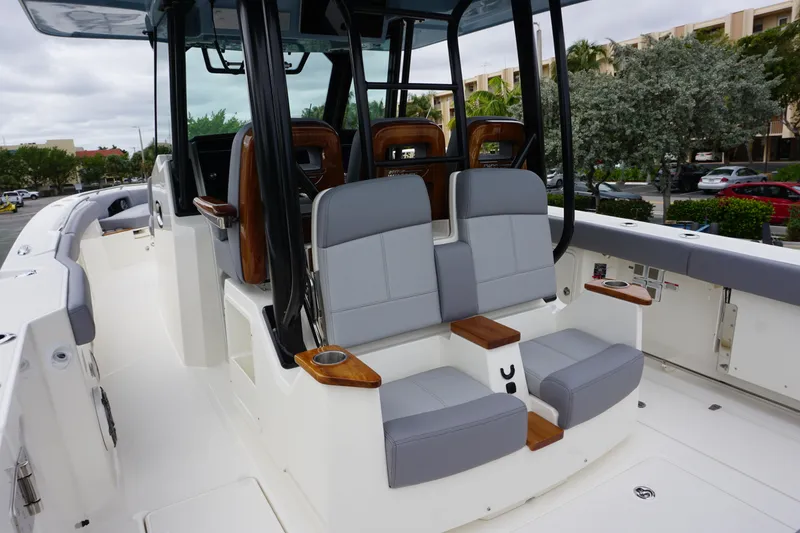 Slide: The Image of 2024 Boston Whaler 360 Outrage boat interior with cushioned seating and modern design. - 38