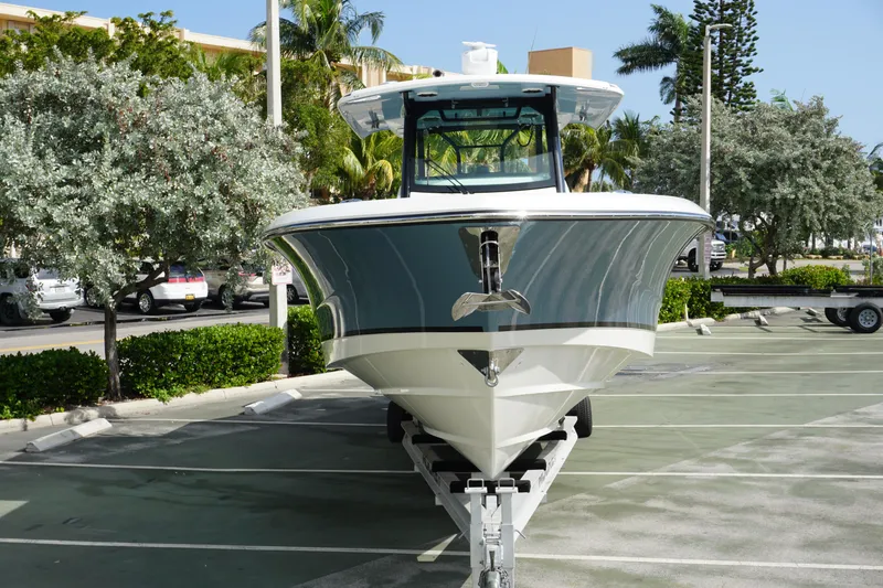 Slide: The Image of 2024 Boston Whaler 360 Outrage boat on trailer in parking lot. - 4