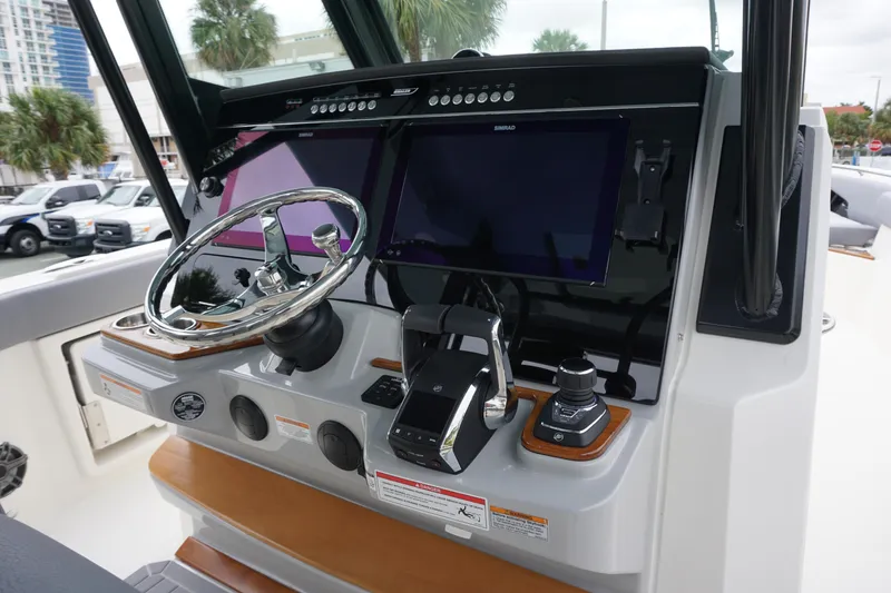 Slide: The Image of 2024 Boston Whaler 360 Outrage helm with dual screens and advanced controls. - 42