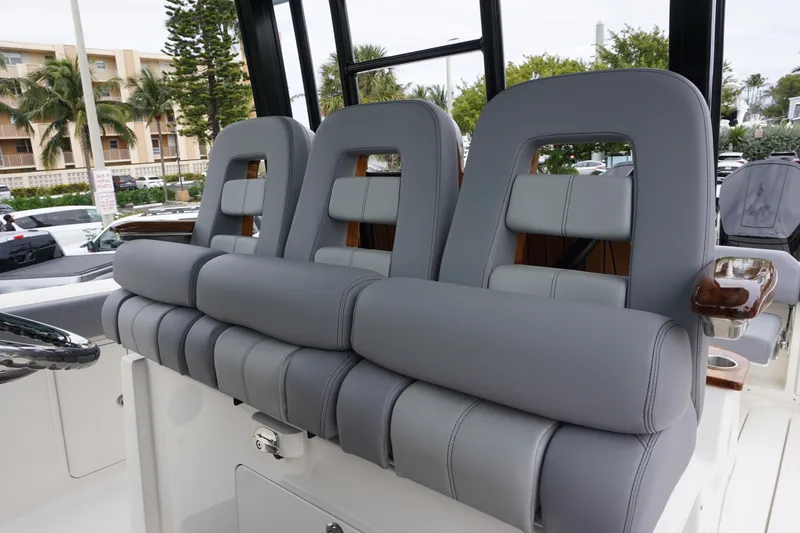 Slide: The Image of 2024 Boston Whaler 360 Outrage boat with luxurious gray seating. - 44