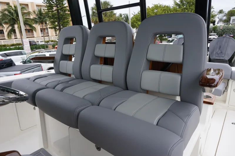 Slide: The Image of 2024 Boston Whaler 360 Outrage boat seating with luxurious gray upholstery. - 45