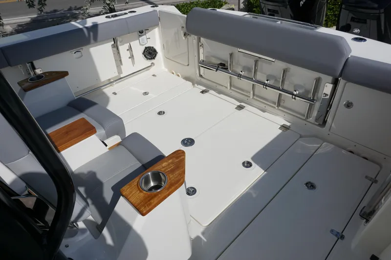 Slide: The Image of 2024 Boston Whaler 360 Outrage boat interior with seating and cup holders. - 9