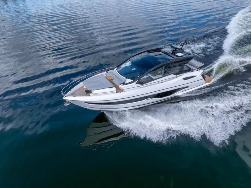 Slide: The Image of 2025 Sunseeker Predator 55 yacht cruising on calm waters. - 10