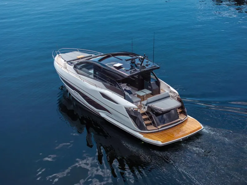 Slide: The Image of 2025 Sunseeker Predator 55 yacht cruising on calm blue waters. - 14