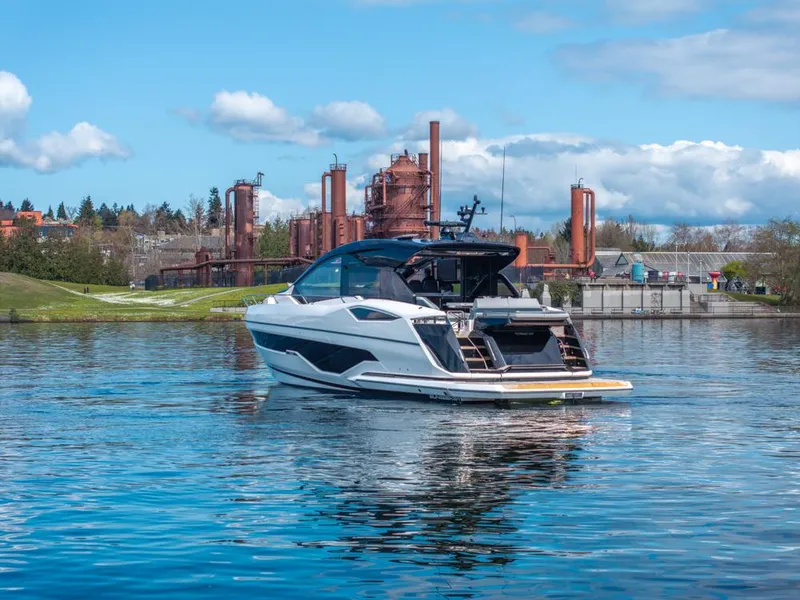 Slide: The Image of 2025 Sunseeker Predator 55 yacht on a serene lake under a cloudy sky. - 15