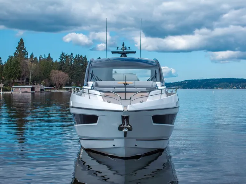 Slide: The Image of 2025 Sunseeker Predator 55 yacht on calm water with industrial backdrop. - 20
