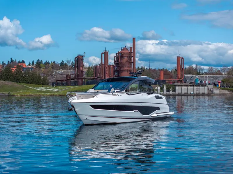 Slide: The Image of 2025 Sunseeker Predator 55 yacht on serene lake with forested shoreline. - 22