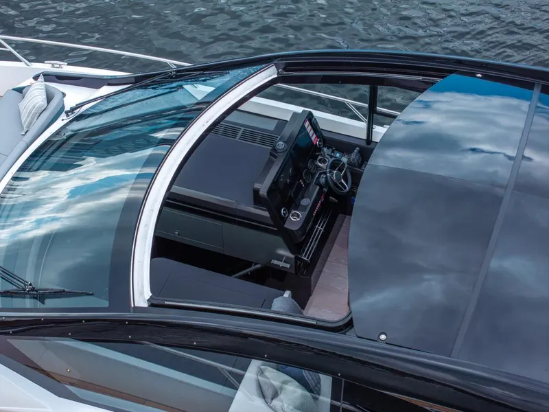 Slide: The Image of 2025 Sunseeker Predator 55 yacht cockpit with sleek design and modern controls. - 26