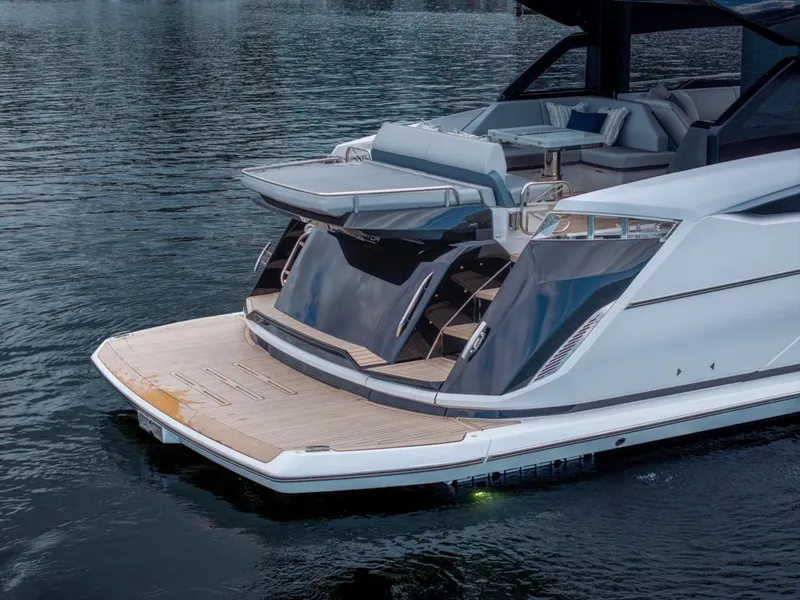 Slide: The Image of 2025 Sunseeker Predator 55 yacht with open deck and seating on calm water. - 28