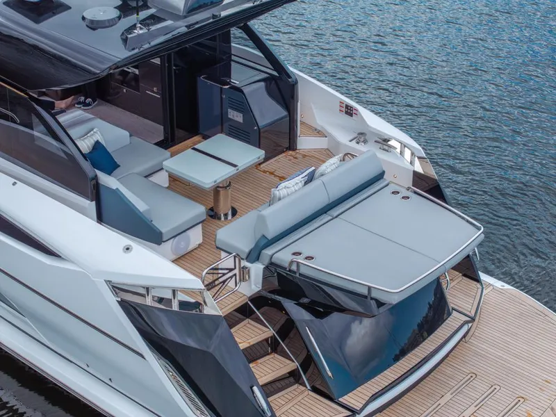 Slide: The Image of 2025 Sunseeker Predator 55 yacht with luxurious deck seating and sleek design on water. - 31