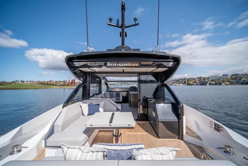 Slide: The Image of 2025 Sunseeker Predator 55 yacht with luxurious deck seating and scenic water view. - 32