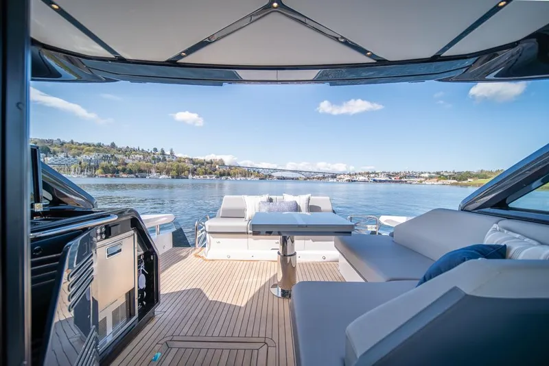 Slide: The Image of 2025 Sunseeker Predator 55 yacht with luxurious deck and scenic water view. - 36