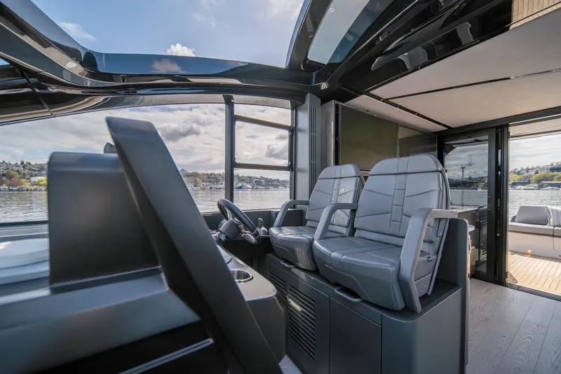 Slide: The Image of 2025 Sunseeker Predator 55 yacht interior with modern helm and seating. - 44