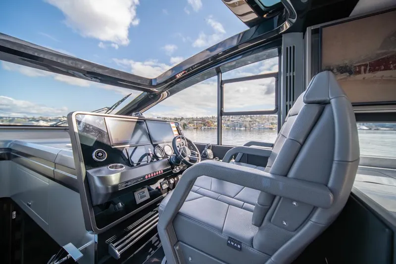 Slide: The Image of Helm of 2025 Sunseeker Predator 55 yacht with modern controls and panoramic view. - 5