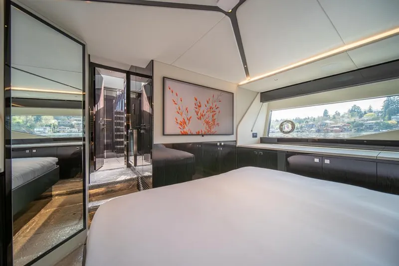 Slide: The Image of Luxurious interior of 2025 Sunseeker Predator 55 yacht bedroom with modern decor and large window. - 50